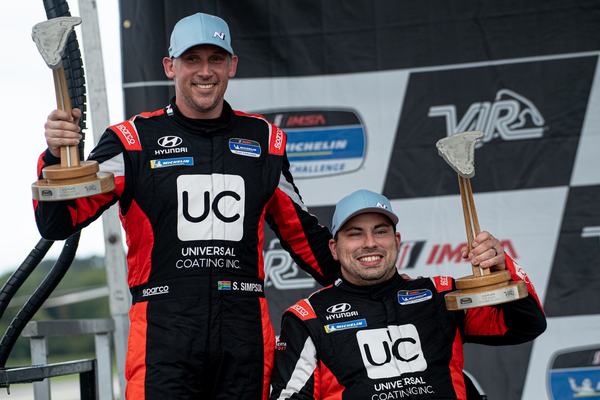 Michael and Stephen Simpson celebrating on the podium, 2021